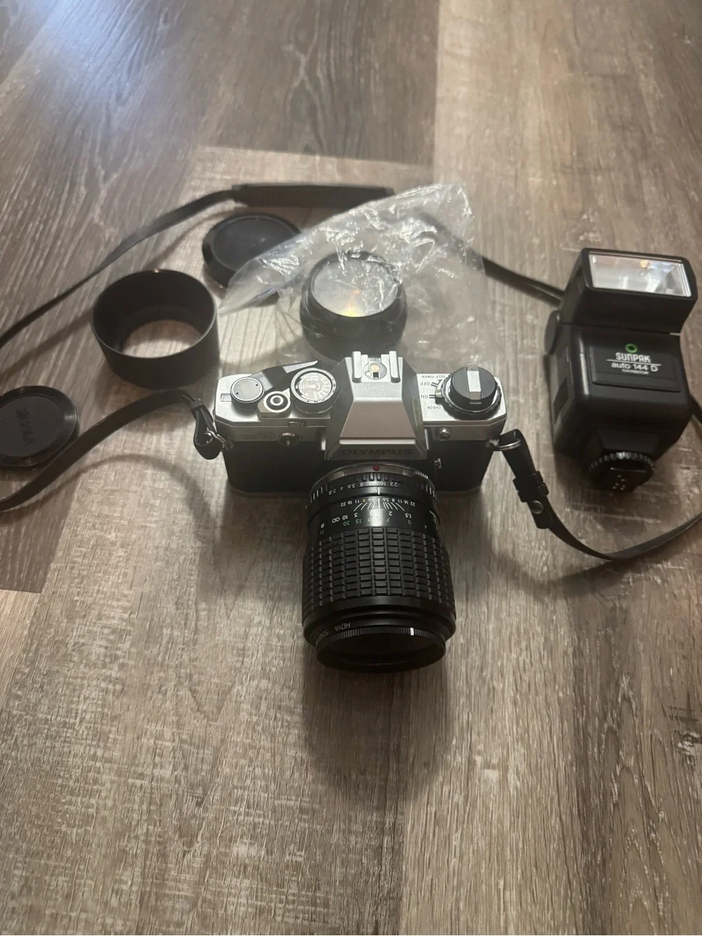 Olympus OM-10 35mm SLR Camera in Silver and Black with Telephoto Lens